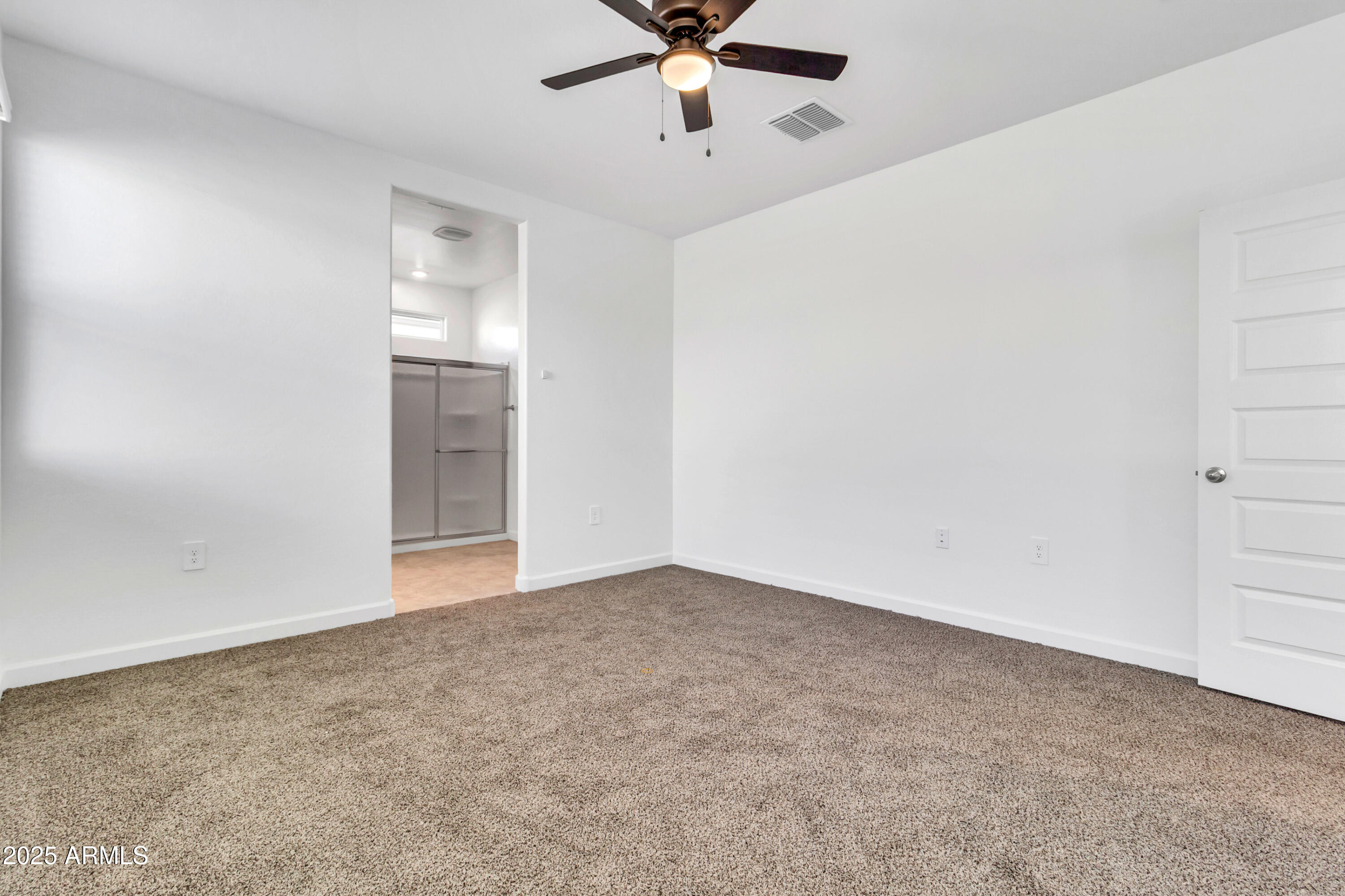 2108 West Sheridan Avenue Apache Junction, AZ 85120 - Photo 20 of 49 an empty room with chandelier fan