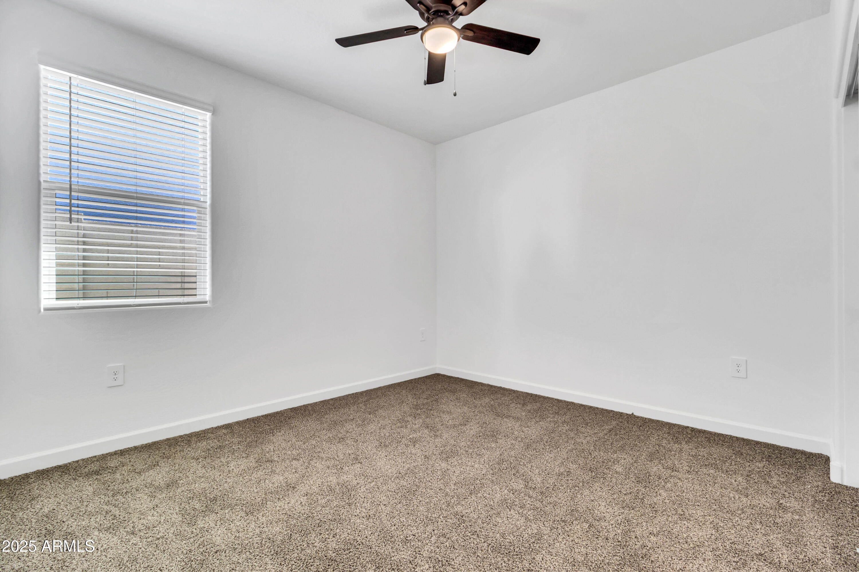2108 West Sheridan Avenue Apache Junction, AZ 85120 - Photo 22 of 49 an empty room with window and ceiling fan