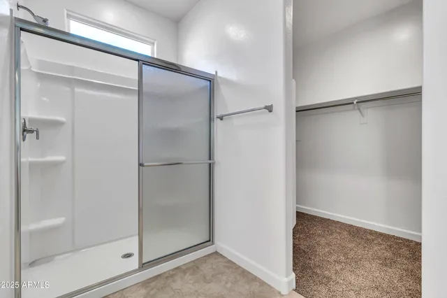 a view of walk in closet with empty racks