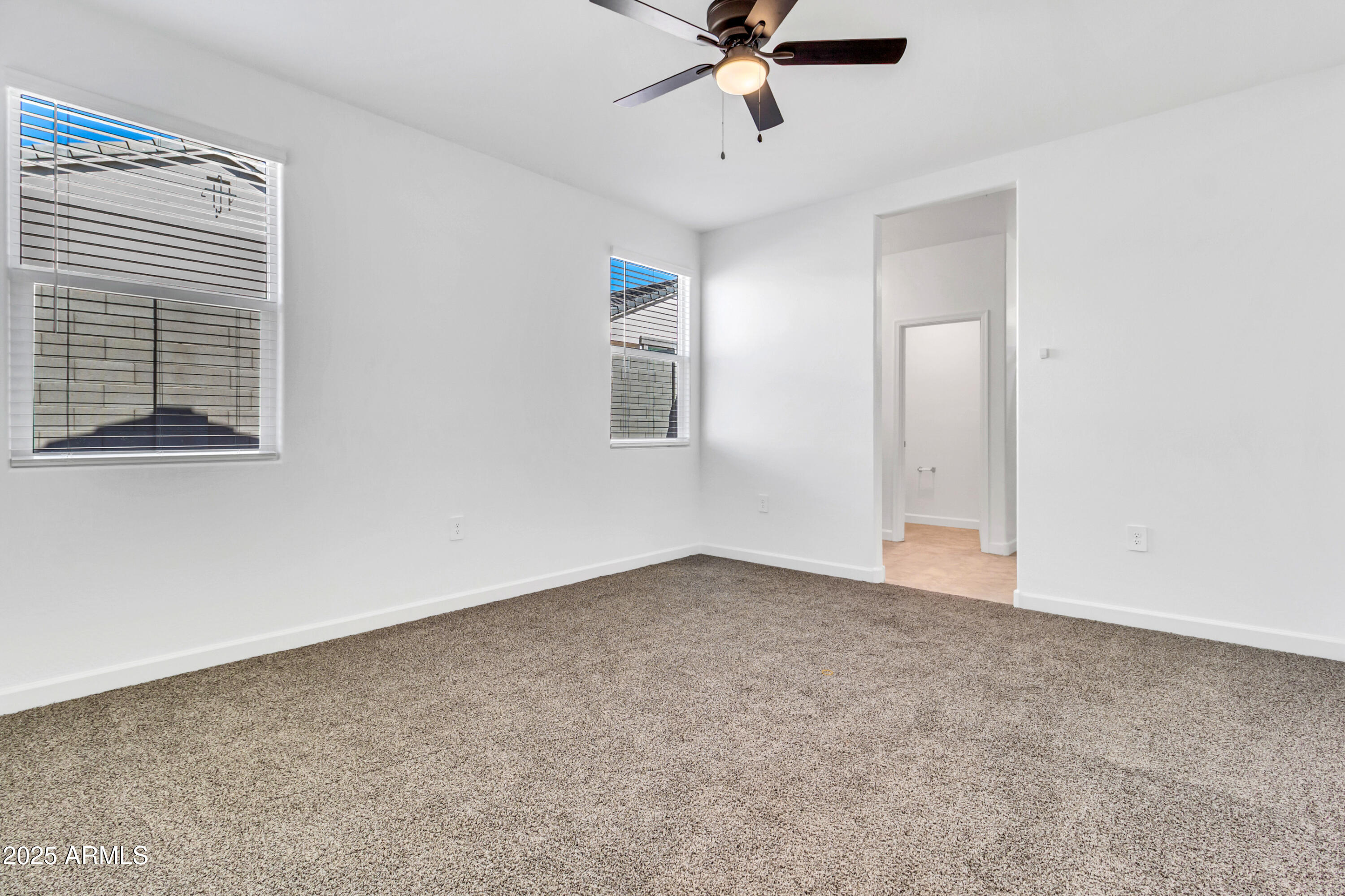 2108 West Sheridan Avenue Apache Junction, AZ 85120 - Photo 28 of 49 an empty room with a window and a fan