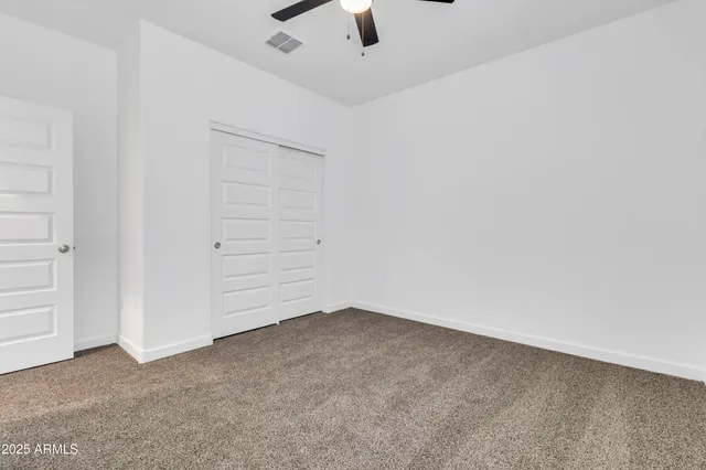 an empty room with a ceiling fan