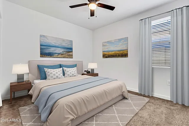 a bedroom with bed and ceiling fan