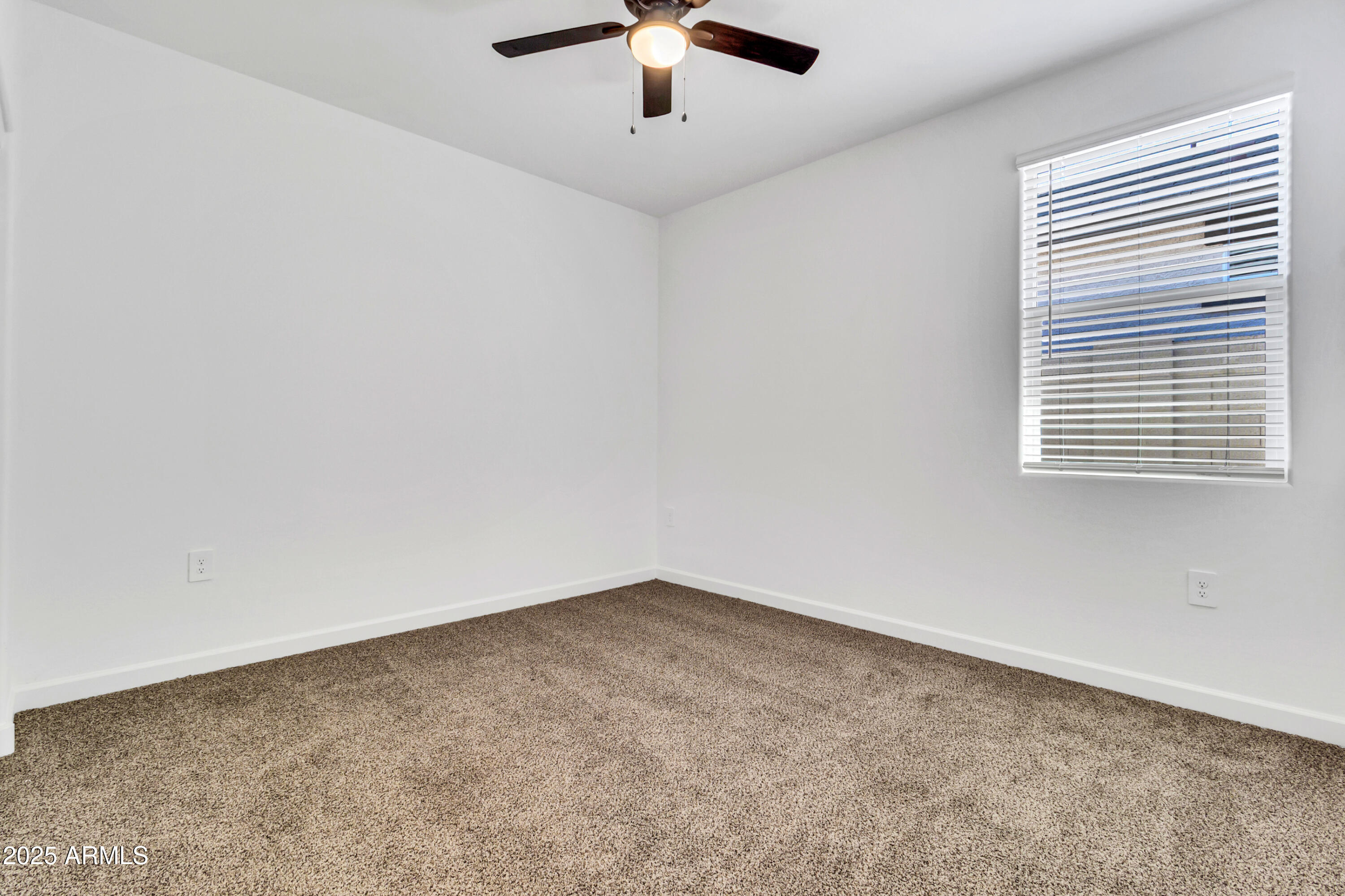 2108 West Sheridan Avenue Apache Junction, AZ 85120 - Photo 33 of 49 an empty room with a ceiling fan and window