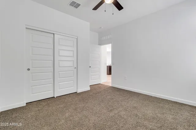 an empty room with closet area