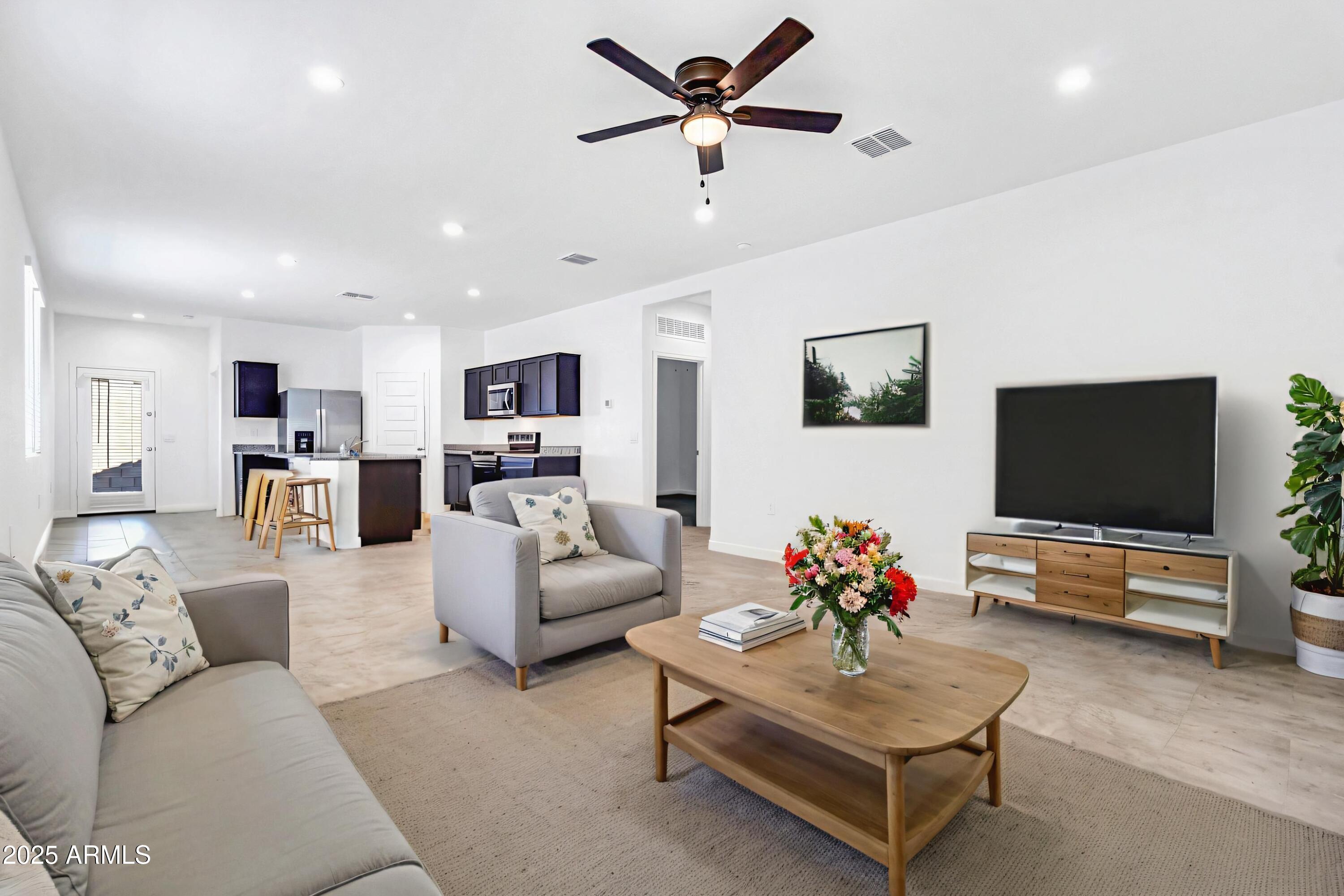 2108 West Sheridan Avenue Apache Junction, AZ 85120 - Photo 5 of 49 a living room with furniture and a flat screen tv