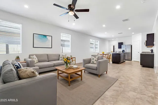 a living room with furniture and a chandelier