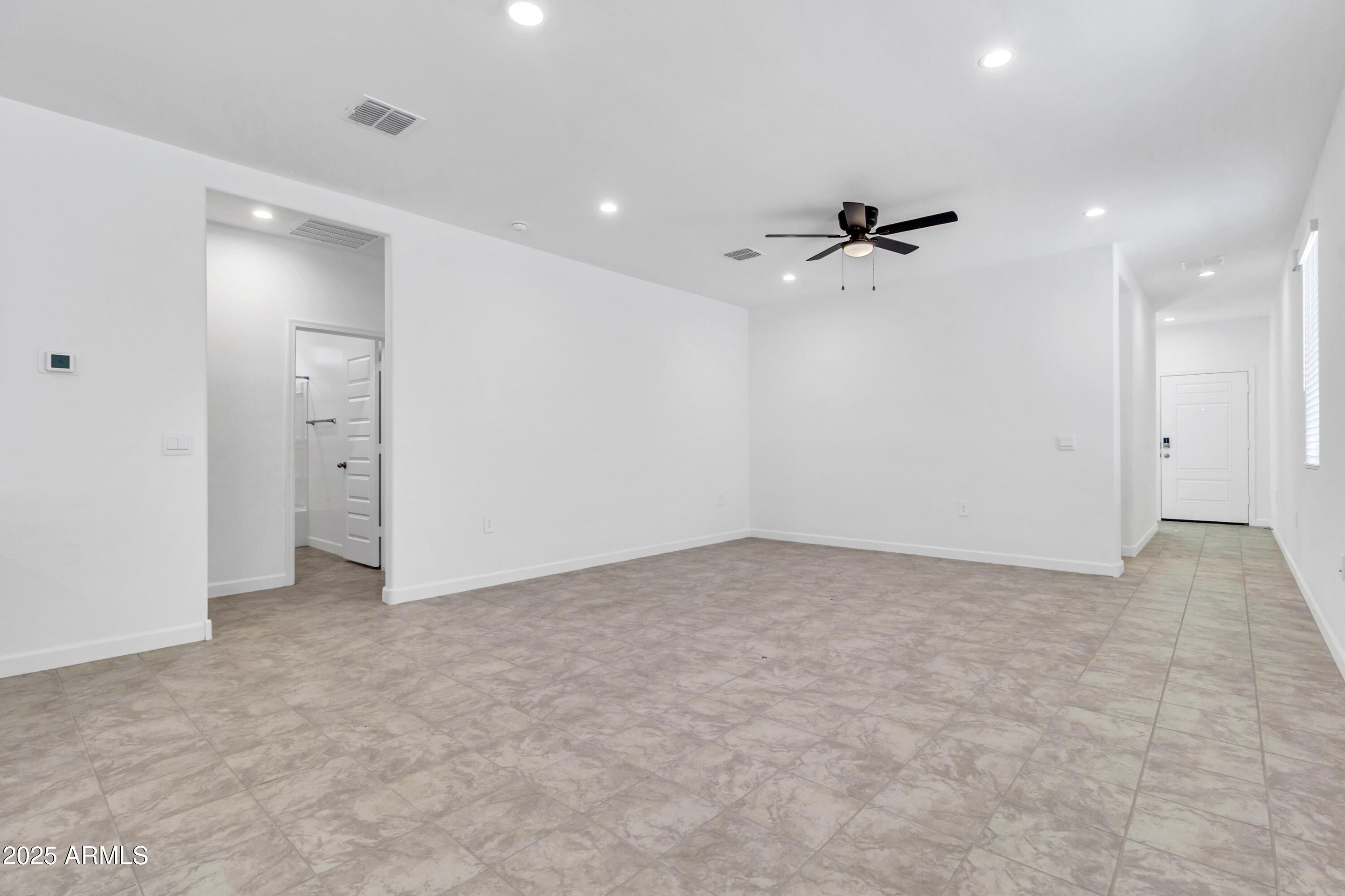 2108 West Sheridan Avenue Apache Junction, AZ 85120 - Photo 8 of 49 an empty room with fan and windows