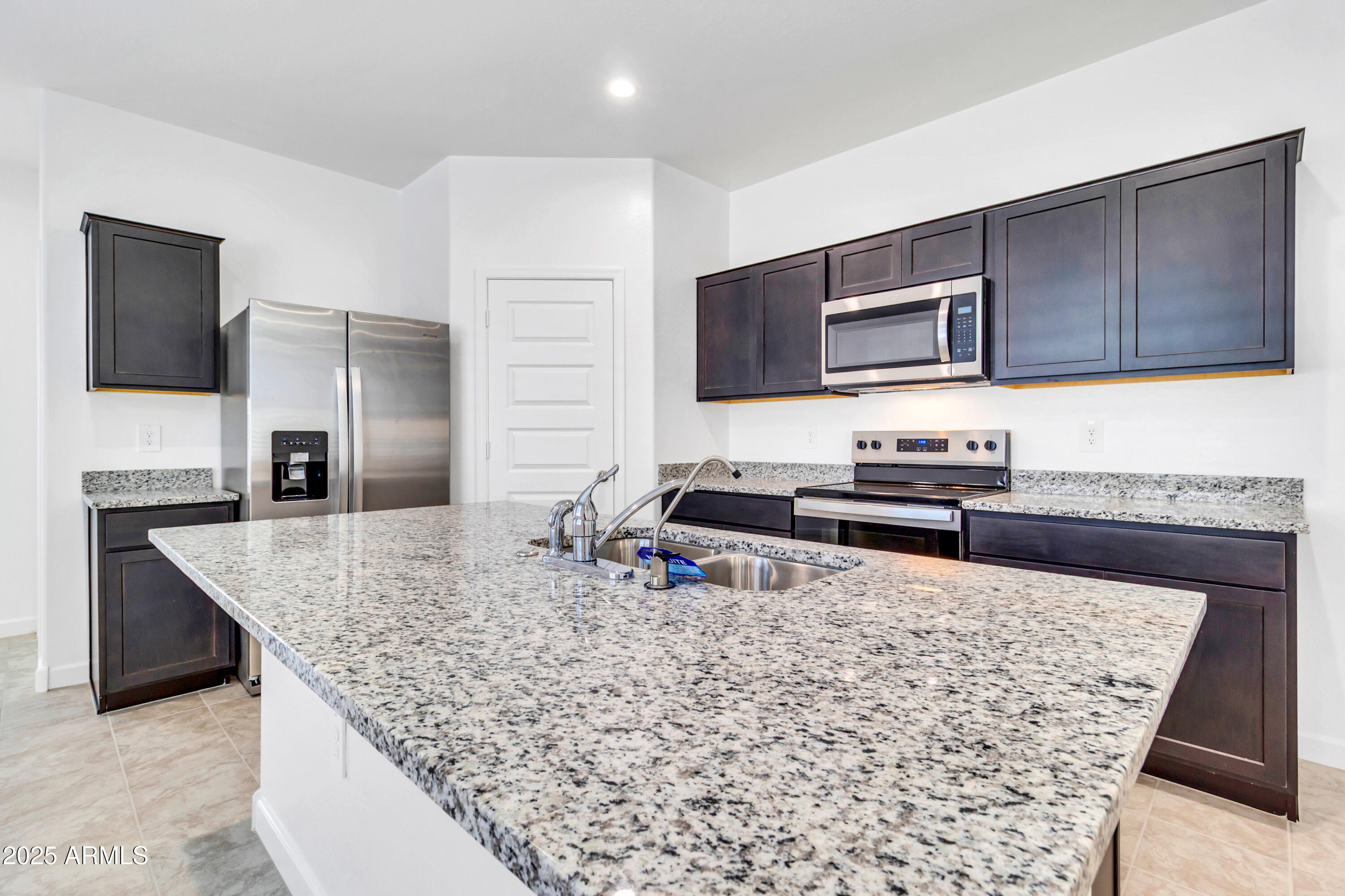2108 West Sheridan Avenue Apache Junction, AZ 85120 - Photo 9 of 49 a kitchen with stainless steel appliances granite countertop a sink stove and refrigerator