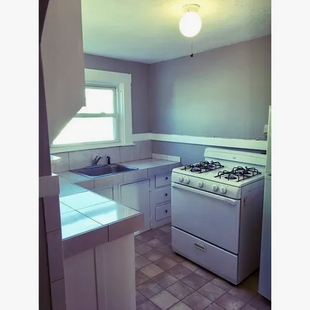 a kitchen with a stove and a sink