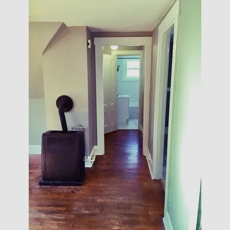 a view of a hallway with wooden floor