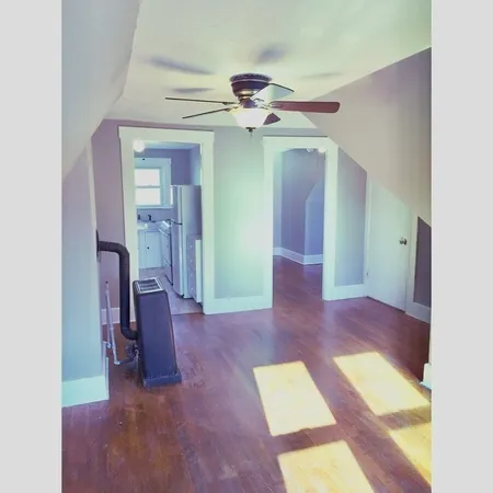 a view of hallway with chandelier and a livingroom