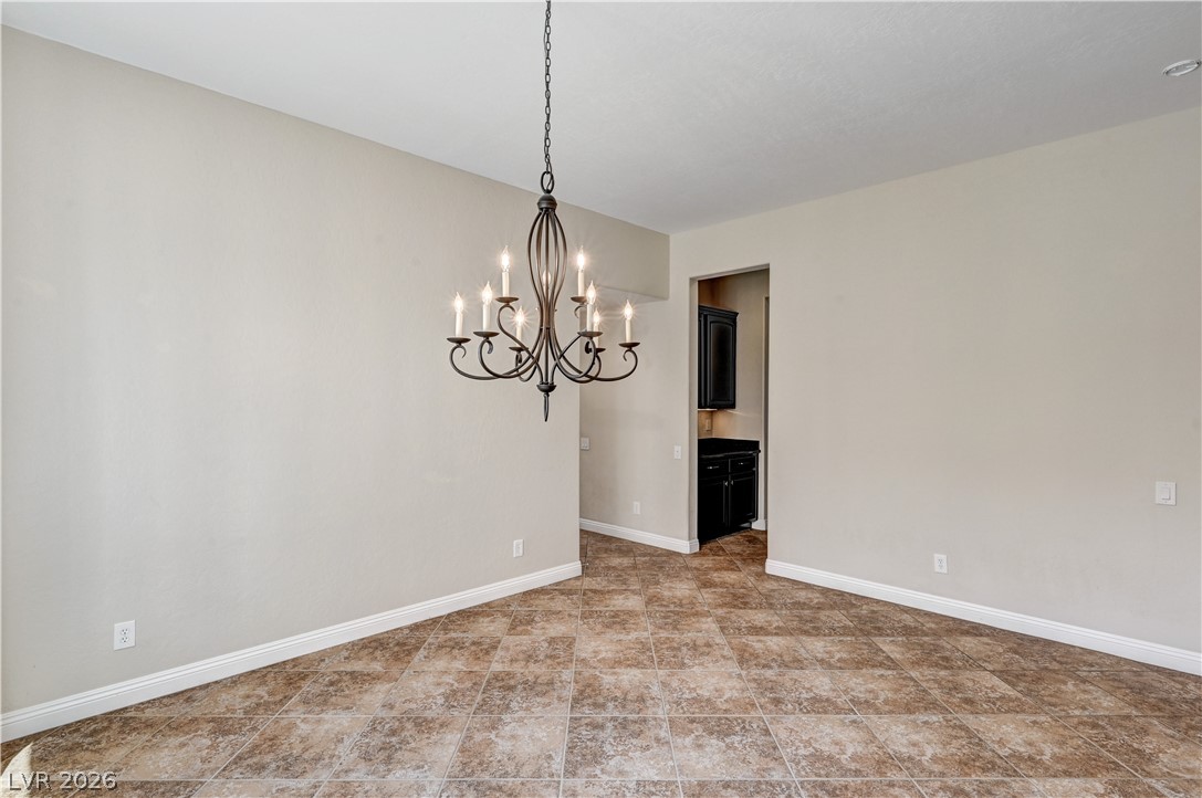 2793 Rosenhearty Drive Henderson, NV 89044 - Photo 28 of 85 This formal dining space, complete with a classic chandelier and durable tile flooring, is ready for entertaining.