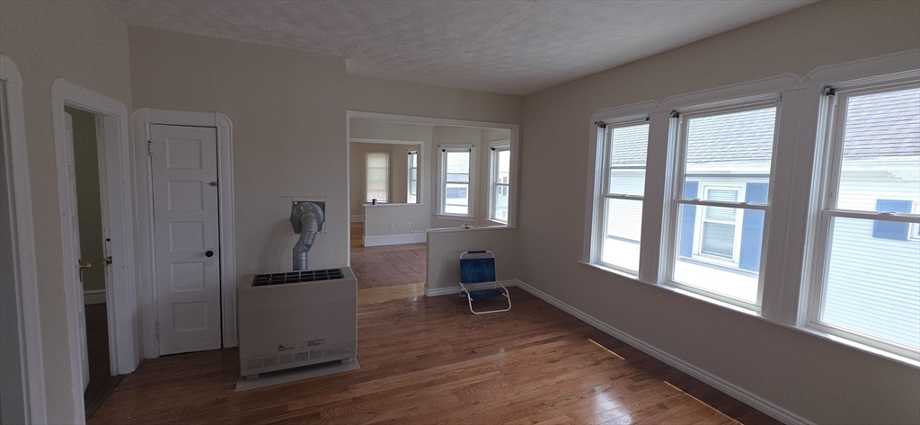 105 6th Street, Unit 3 Fall River, MA 02721 - Photo 5 of 10 a view of empty room with wooden floor and fan