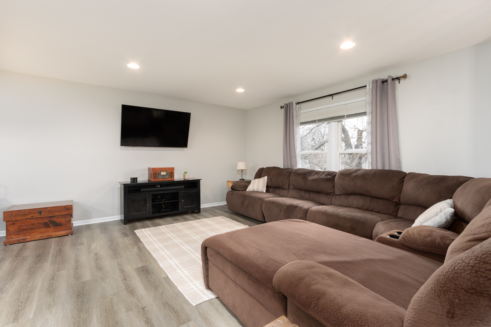 202 Augusta Drive McHenry, IL 60050 - Photo 3 of 18 a living room with furniture and a flat screen tv