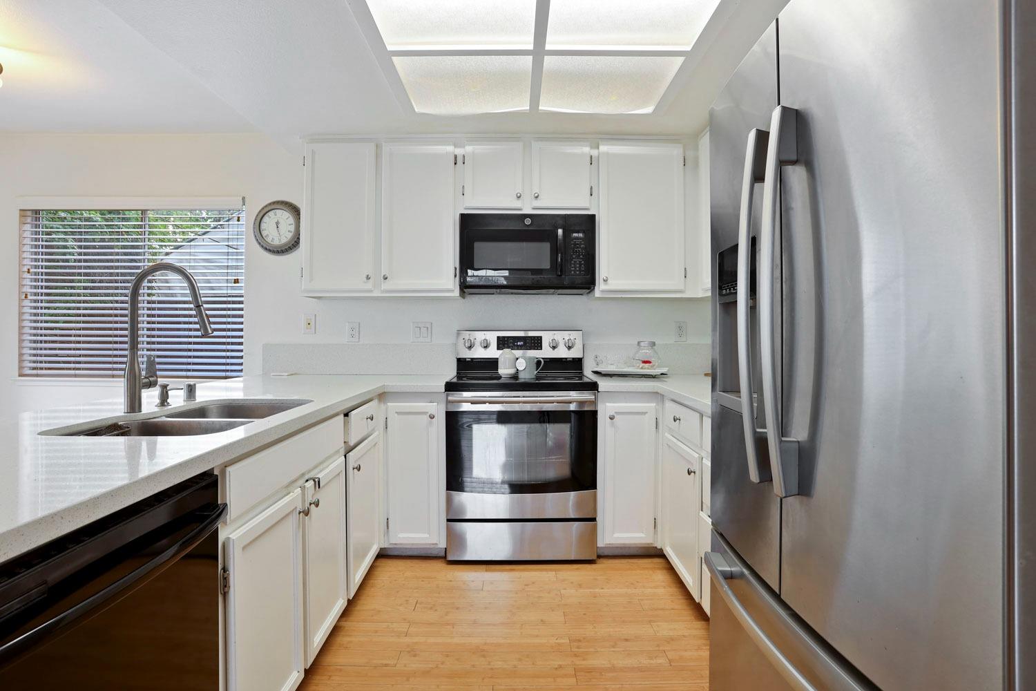 145 Machado Court Tracy, CA 95376 - Photo 11 of 28 a kitchen with stainless steel appliances a refrigerator sink and microwave