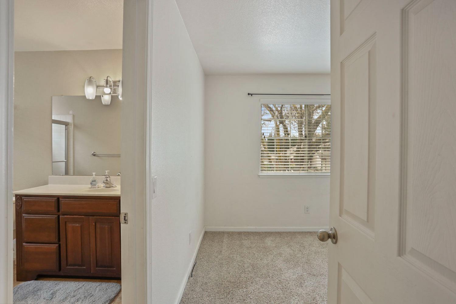 145 Machado Court Tracy, CA 95376 - Photo 14 of 28 a bathroom with a sink vanity and mirror