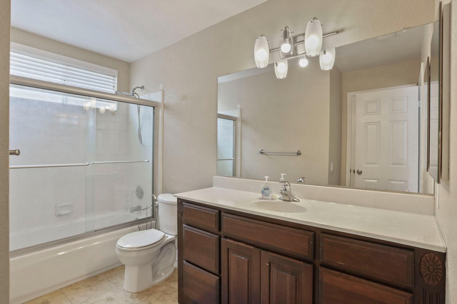 145 Machado Court Tracy, CA 95376 - Photo 17 of 28 a bathroom with a sink a toilet and shower