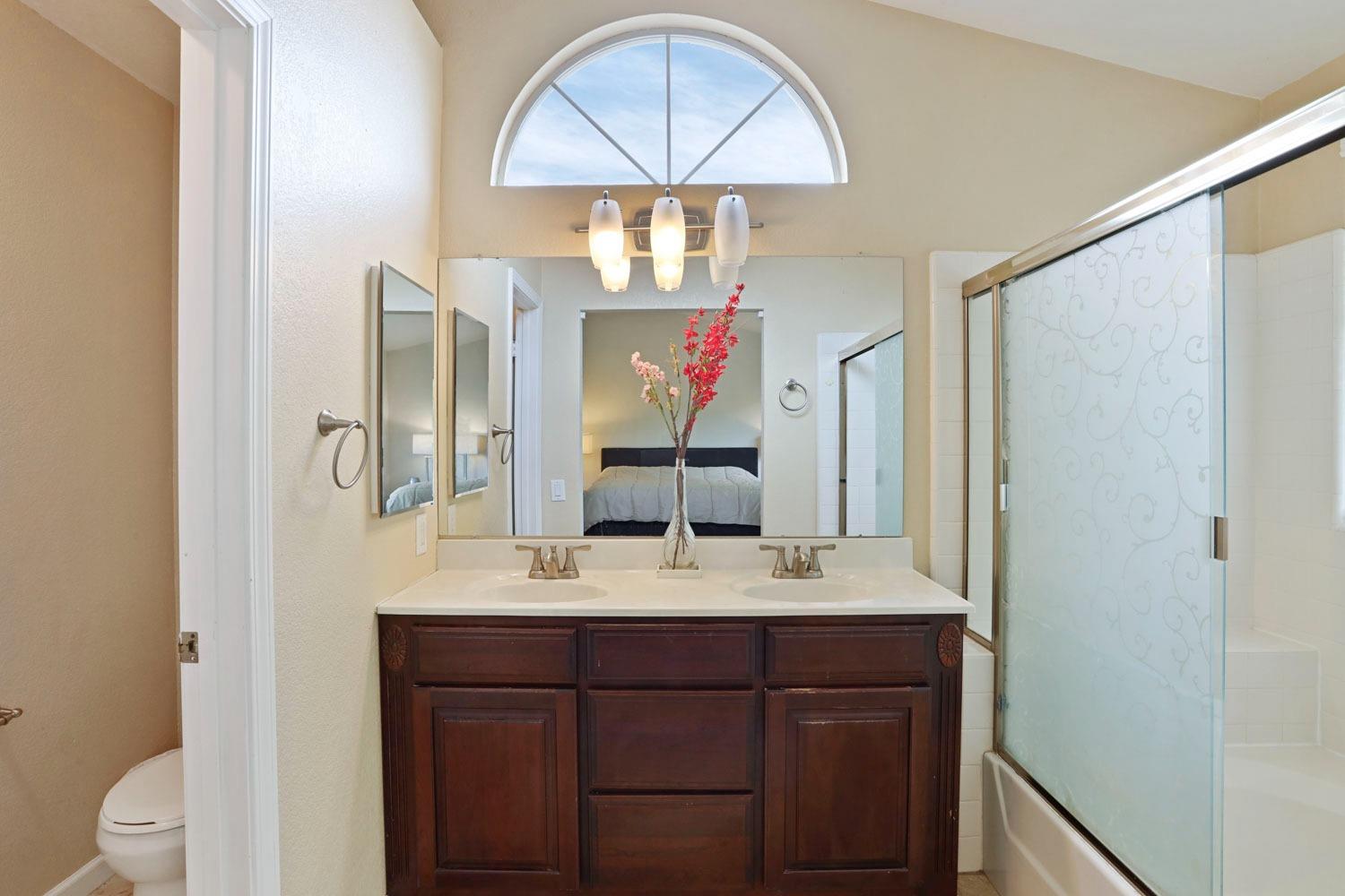 145 Machado Court Tracy, CA 95376 - Photo 20 of 28 a bathroom with a sink and a mirror