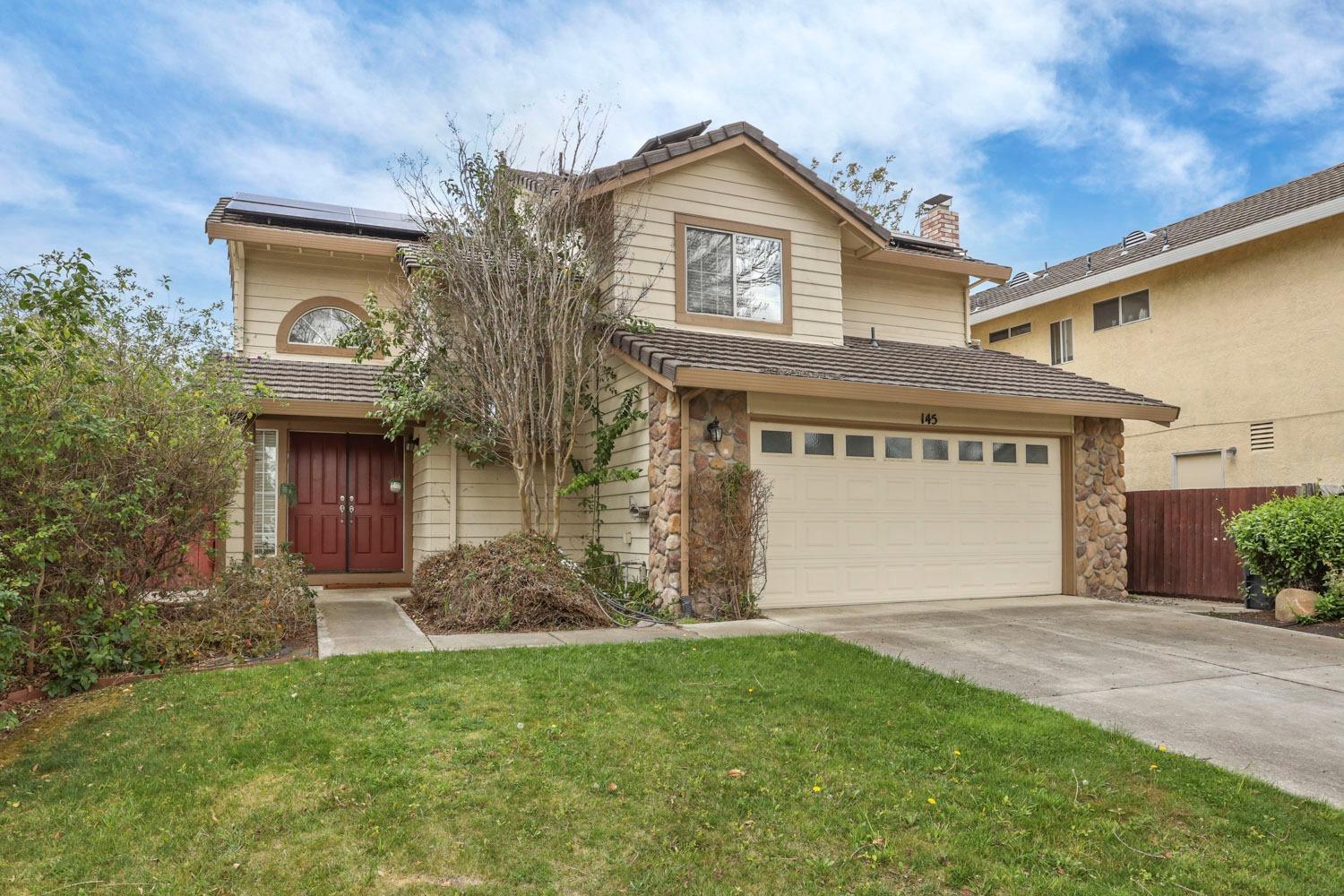 145 Machado Court Tracy, CA 95376 - Photo 3 of 28 a front view of a house with garden