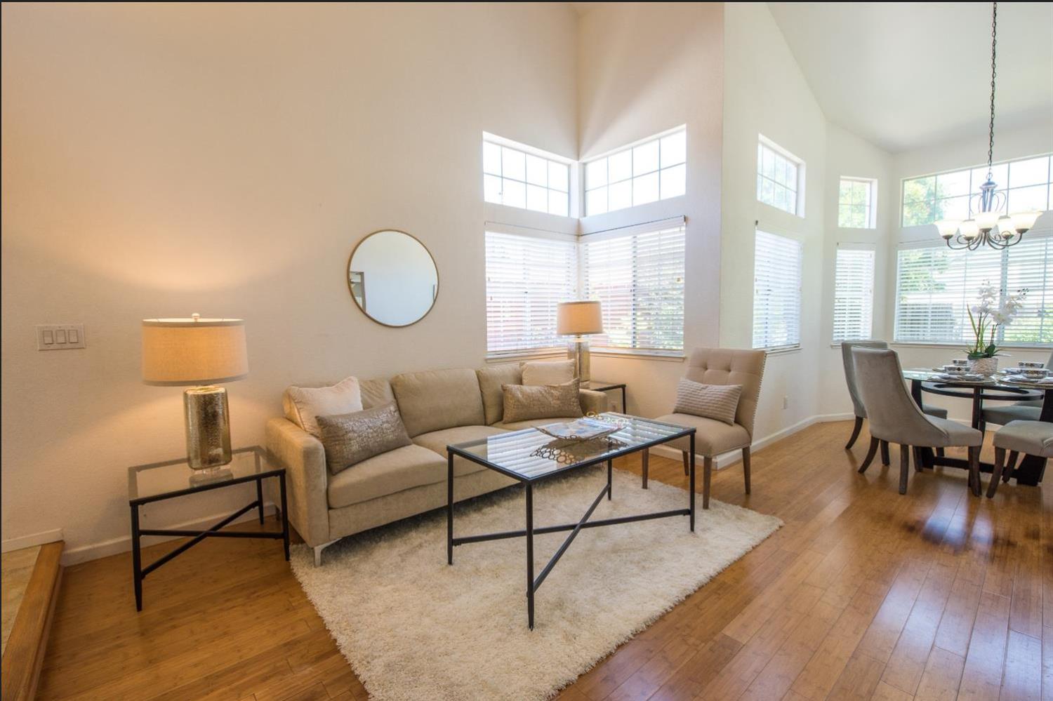 145 Machado Court Tracy, CA 95376 - Photo 5 of 28 a living room with furniture a lamp a potted plant and a large window