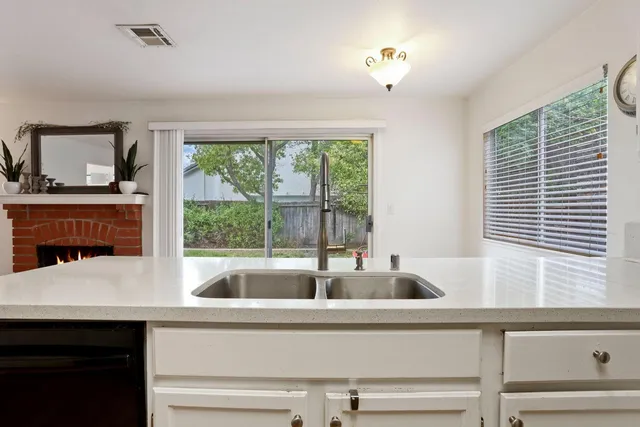 a living room with furniture and large windows