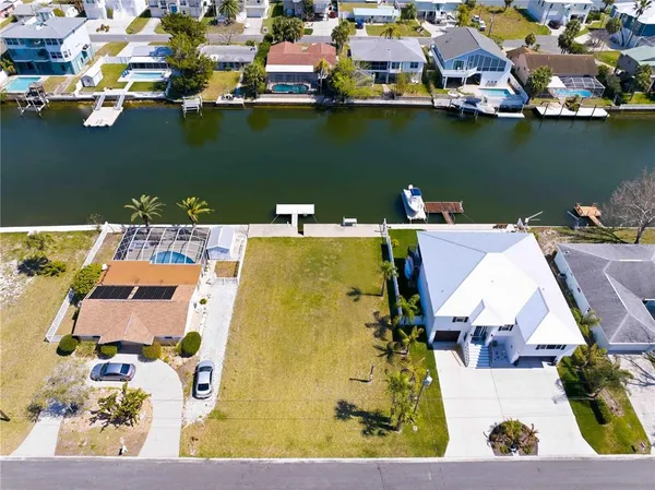 an aerial view of a house with a lake view