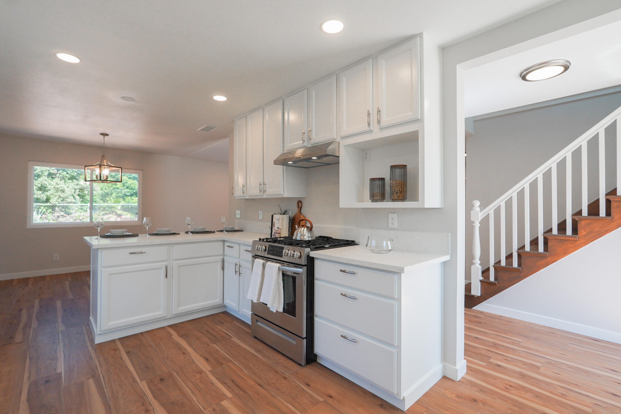 926 Talbert Avenue Simi Valley, CA 93065 - Photo 9 of 40 a kitchen with stainless steel appliances granite countertop a stove a sink dishwasher and a refrigerator with wooden floor