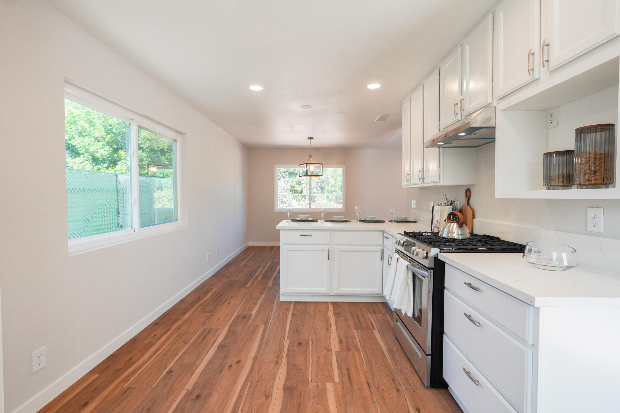 926 Talbert Avenue Simi Valley, CA 93065 - Photo 10 of 40 a kitchen with a stove a sink and wooden floor