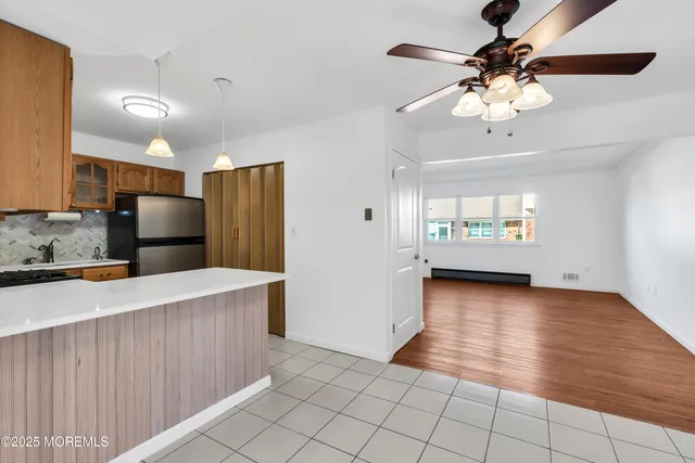 a view of a kitchen with a sink and a refrigerator