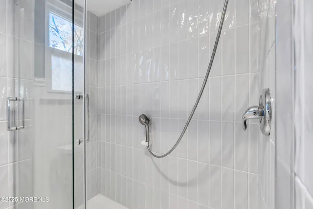 a bathroom with a glass shower door