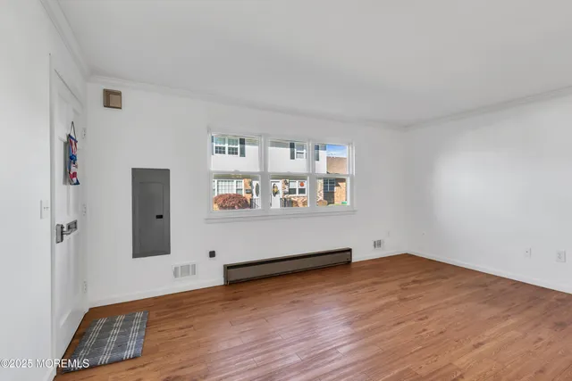 an empty room with wooden floor and closet