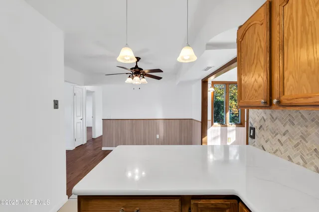 a view of kitchen and living room with a large window