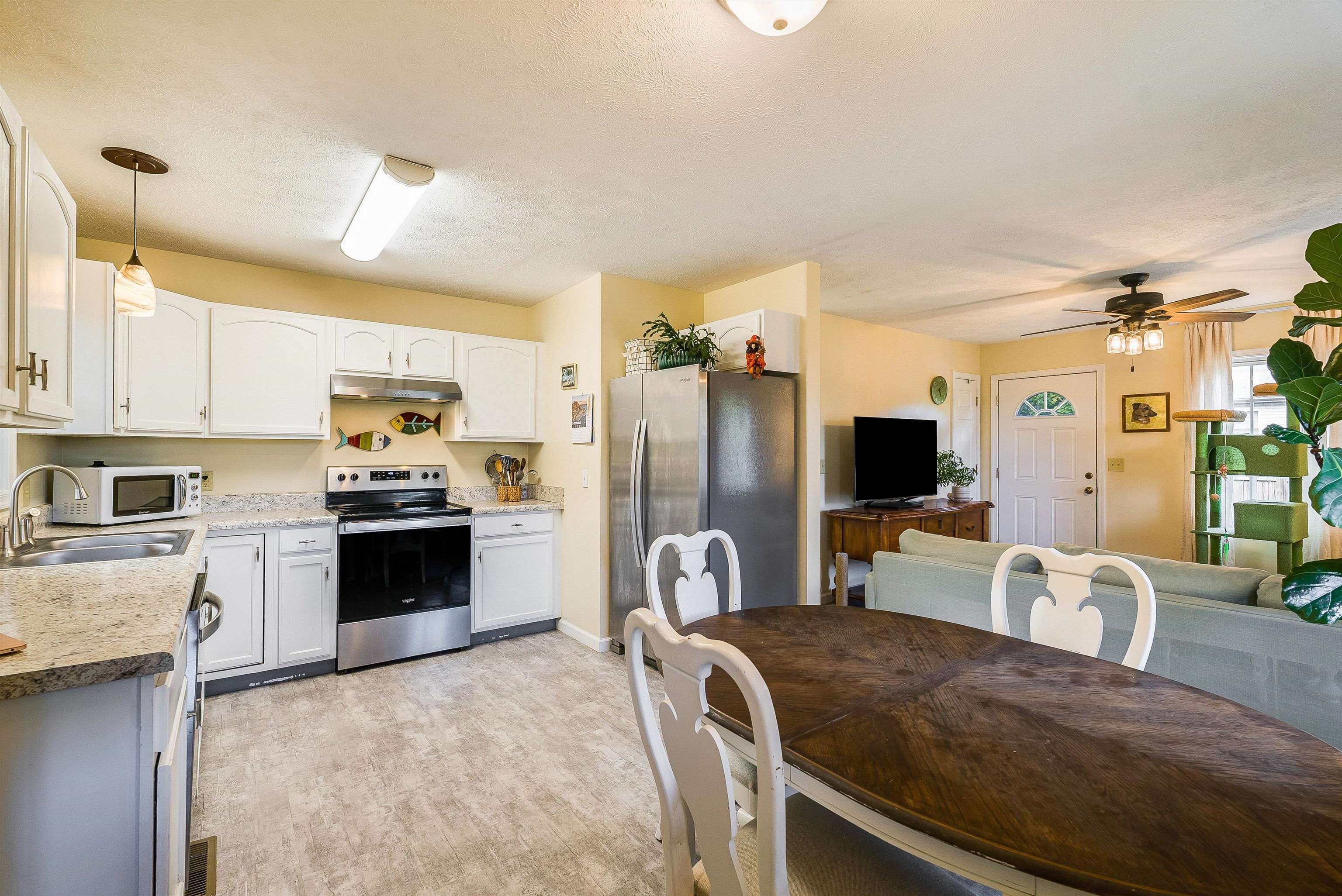 100 Olive Street Staunton, VA 24401 - Photo 14 of 48 a kitchen with stainless steel appliances granite countertop a sink refrigerator stove and microwave