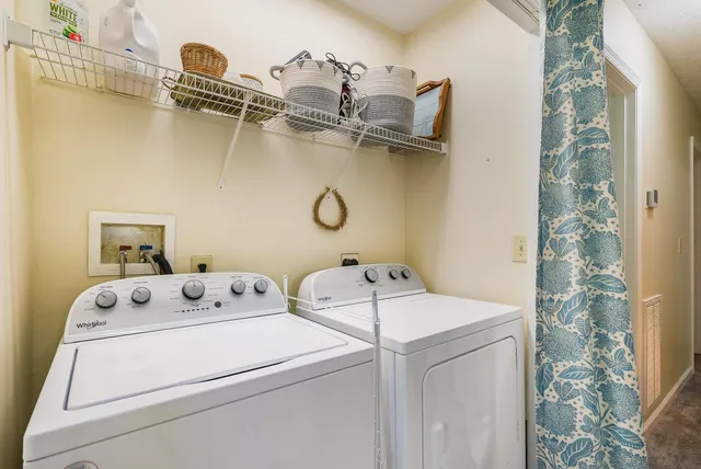 a bathroom with a toilet sink vanity and mirror