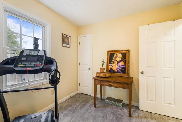 a view of a workspace with furniture and wooden floor