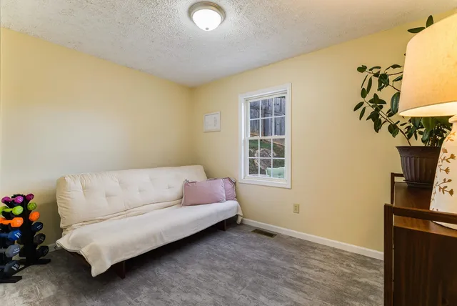 a view of a deck with couches table and chairs with wooden floor and fence