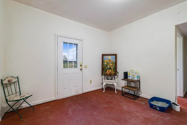 a view of a house with a yard and wooden fence