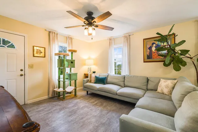 a view of a dining room with furniture and a potted plant