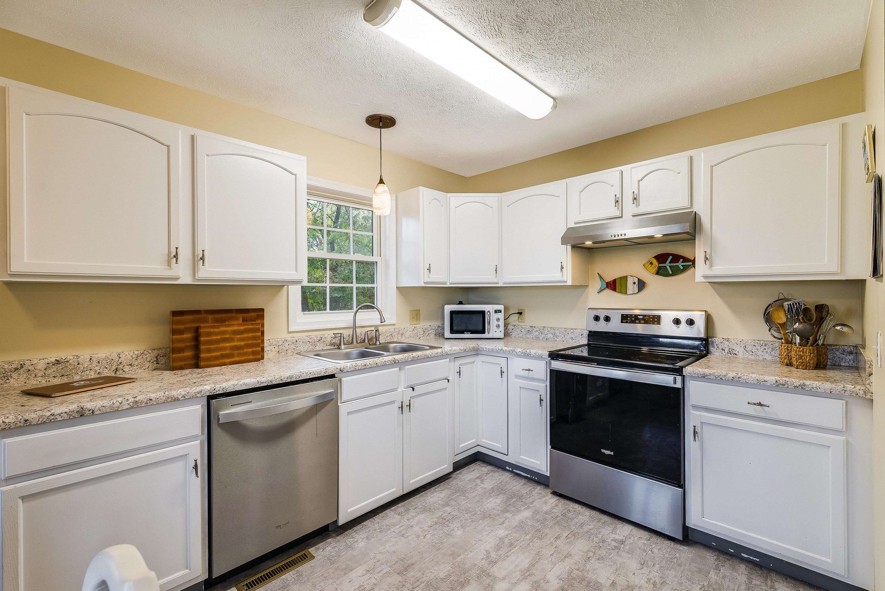 100 Olive Street Staunton, VA 24401 - Photo 9 of 48 a kitchen with granite countertop white cabinets and white appliances