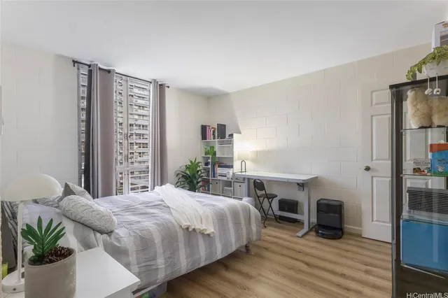 a bedroom with a large bed and a tv