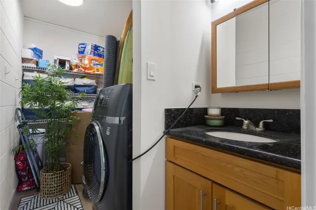 a bathroom with a granite countertop sink a vanity and a shower