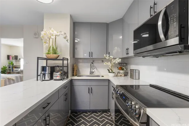 a kitchen with stainless steel appliances granite countertop a sink stove and cabinets