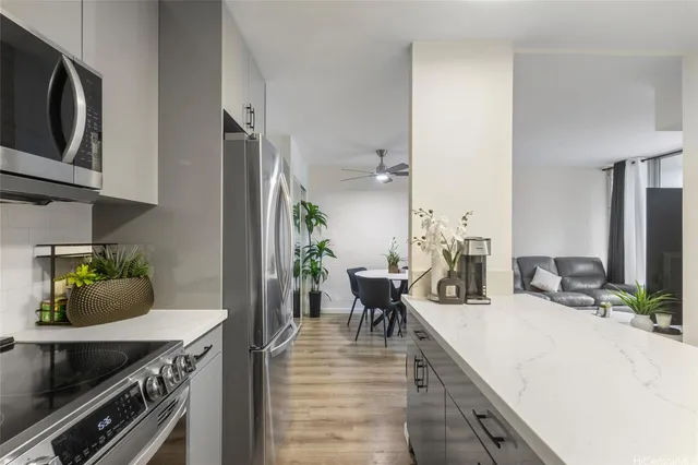 a kitchen with stainless steel appliances granite countertop a sink a stove and cabinets