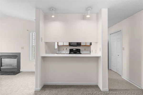 a kitchen with stainless steel appliances granite countertop a refrigerator a sink and a stove
