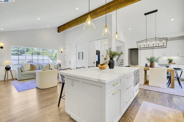 a kitchen with granite countertop white cabinets and window