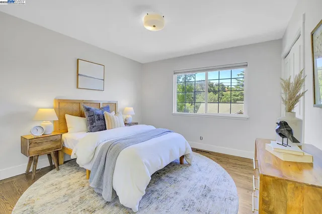 a bedroom with two beds and a window