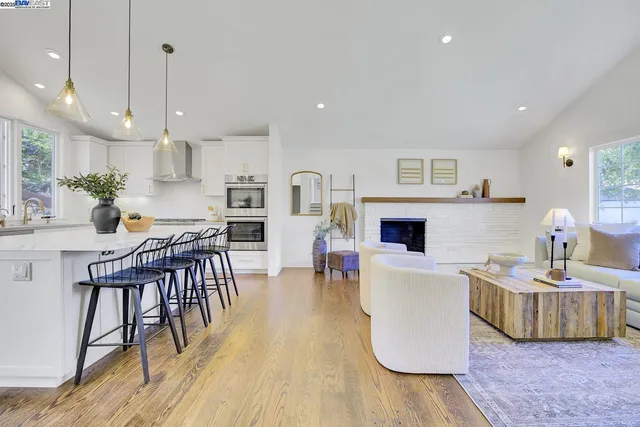 a living room with fireplace furniture and a wooden floor