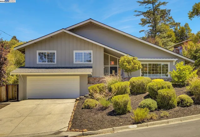 an aerial view of a house with a yard and potted plants