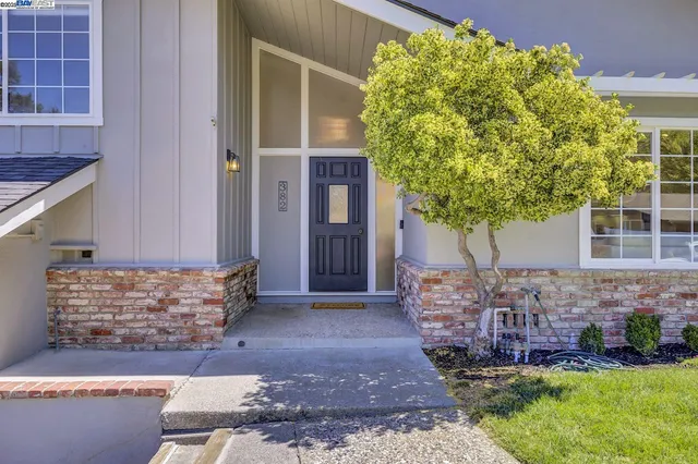a aerial view of a house with a yard and lake view