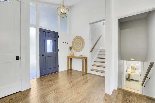 a view of a hallway with entryway wooden floor and front door